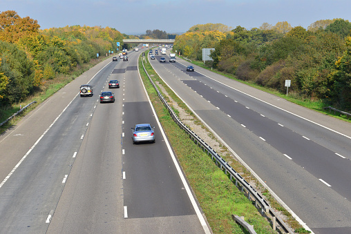 The M23 motorway near the junction with Gatwick Airport at around 13.00 on a October Fall day. The traffic at this time of day is light.