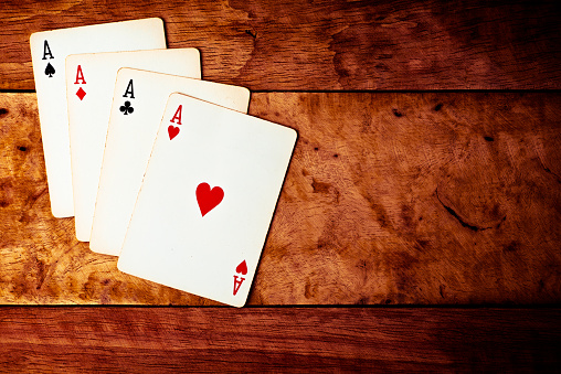 Play card on the Brown grunge texture of wood table vintage color dark tone style