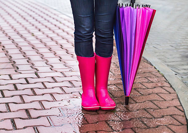 осень. девушка носить резиновые сапоги и с красочные зонтик. - human leg women shower water стоковые фото и изображения
