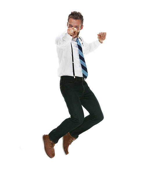 istock Businessman jumping and pointing towards camera 493622510