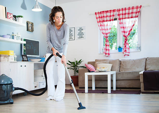 istock Woman with Vacuum Cleaner 493626694