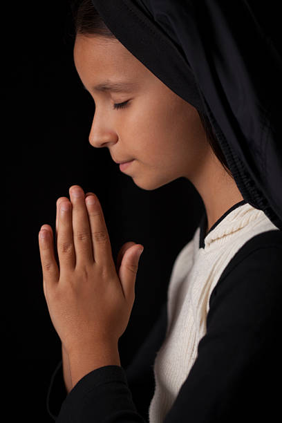 istock Praying little girl 493629716