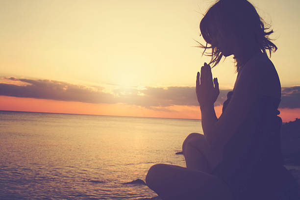 istock Young woman practicing yoga on the beach. 493630102