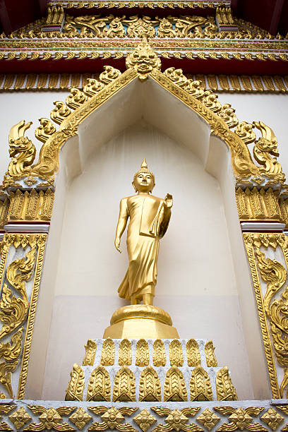 istock Buddha standing statue in a public temple 493630132