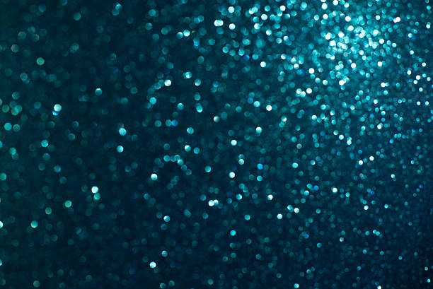 istock glitter vintage lights background.silver, blue and black. de-focused. 493631136