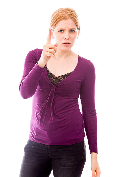Young woman looking serious and pointing