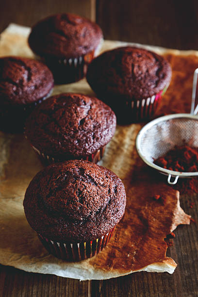 istock chocolate muffin on wooden table 493633936