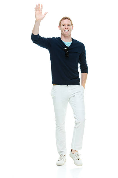 istock Smiling casual man waving hand 493633944