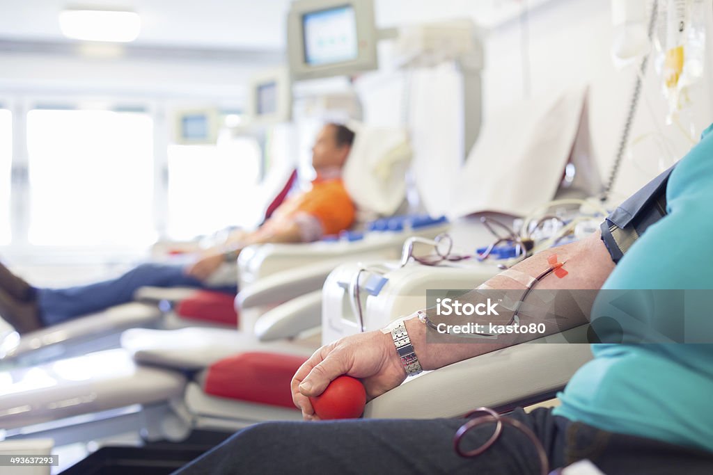 Blood donor at donation. Blood donor at donation with a bouncy ball holding in hand. Adult Stock Photo