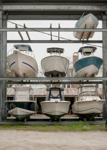 Boats are stored in a marina during the winter season until their owners are ready to use them again