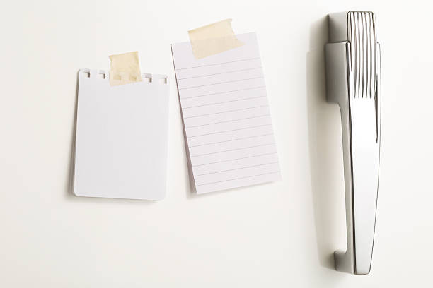 istock Two blank paper notes stuck to a white fridge door 493637905