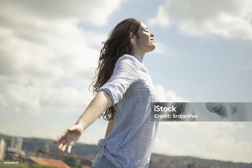 Enjoying the summer breeze Young girl with arms outstretched facing the sun, and enjoying it 20-29 Years Stock Photo