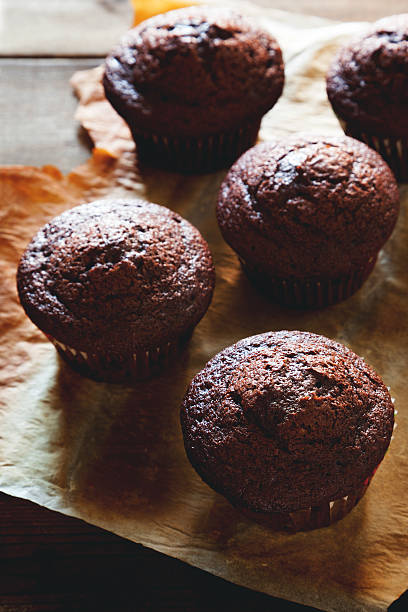 istock chocolate muffin on wooden table 493647122