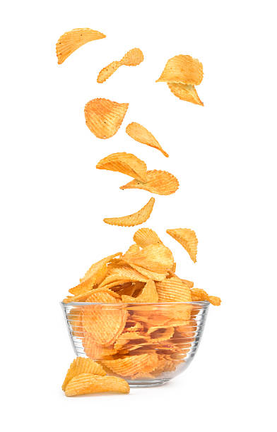 istock Potato chips falling in a bowl isolated on white 493647546