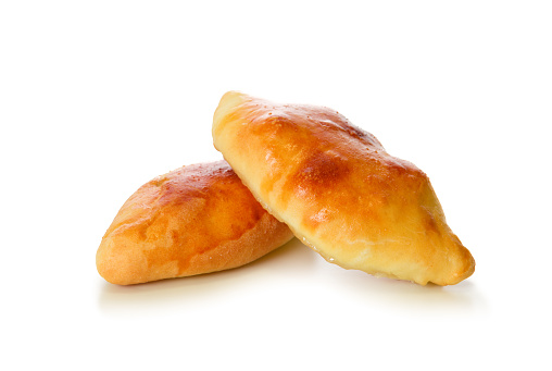 Fresh baked russian pastry pirozhki isolated on white.