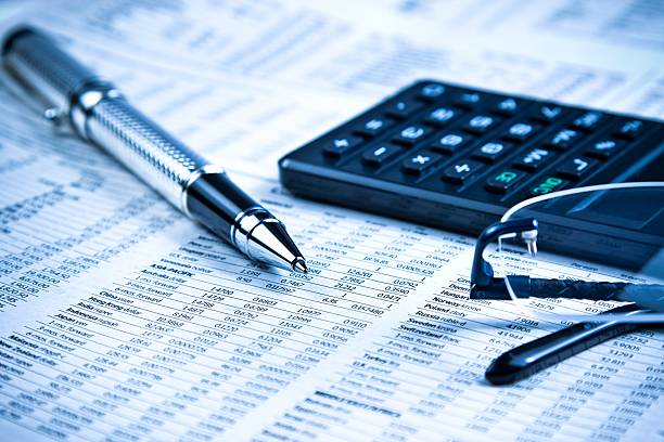 istock business pen, calculator and glasses on financial chart 493648398