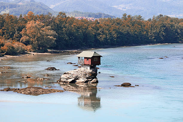istock house on rock Drina river Serbia landscape 493648884