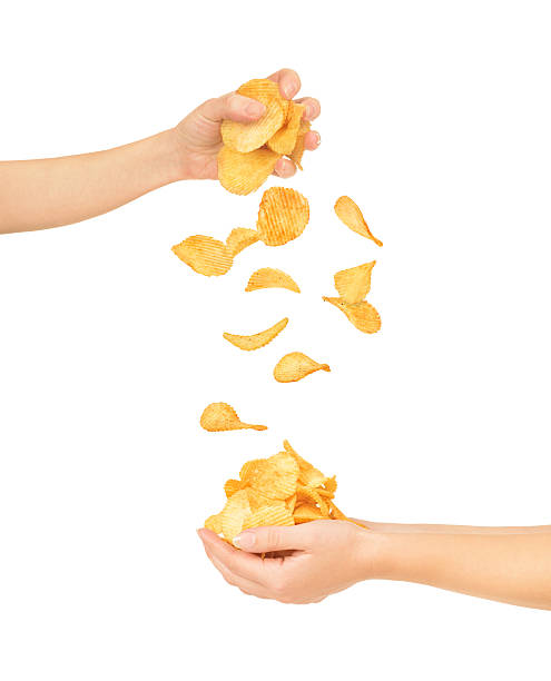 istock Female hands with chips isolated on white 493649226