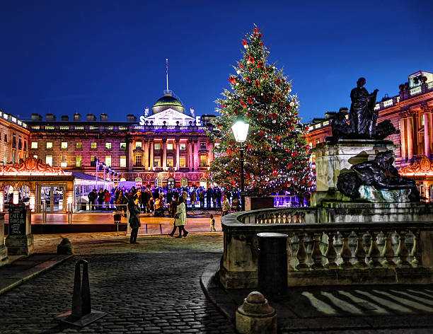 Somerset House at Christmas in the evening London, United Kingdom - November 22, 2012: Christmas tree in Somerset House in front of the ice skating rink in the evening as a small child and family stand around. university of london photos stock pictures, royalty-free photos & images
