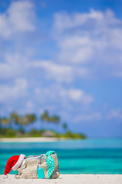 istock Beach accessories with Santa Hat on white tropical beach 493651166