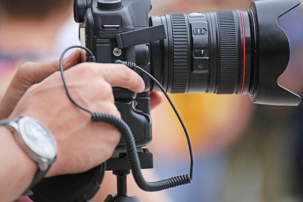 istock Hands holding and shooting slr camera 493651204