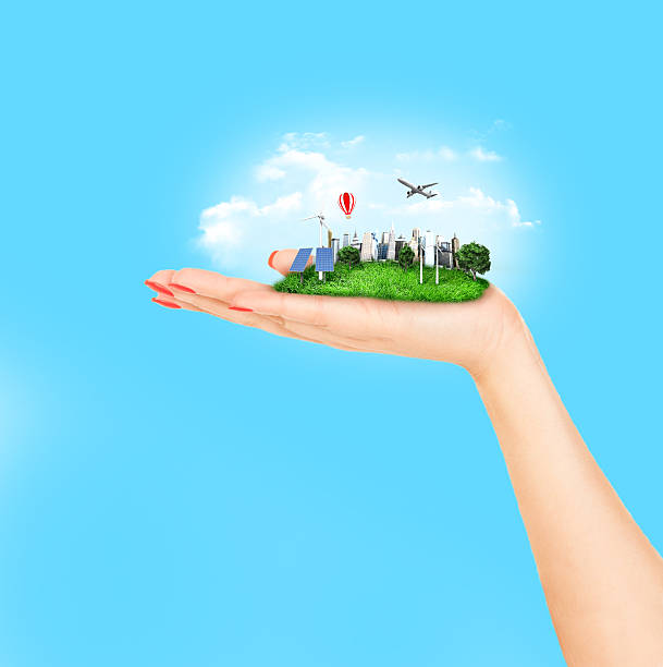 istock human hand holding a city 493652542