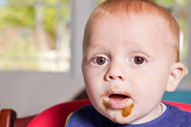 istock Adorable Baby Boy With Green Beans On His Face 493652882