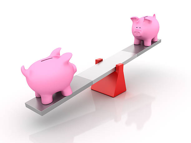 istock Piggy Bang Balancing on a Seesaw 493653906