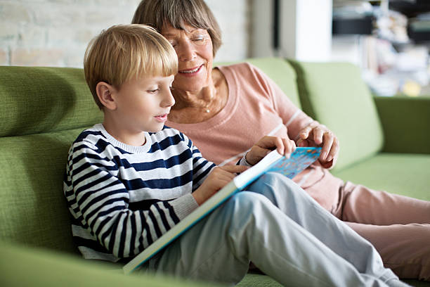 Little boy with grandmother reading a book