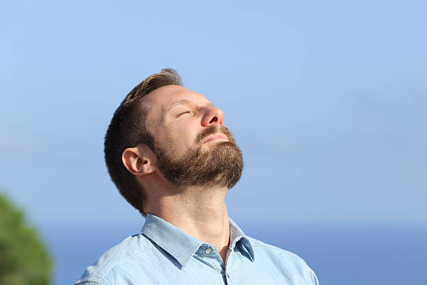 istock Man breathing deep fresh air outdoors 493655334