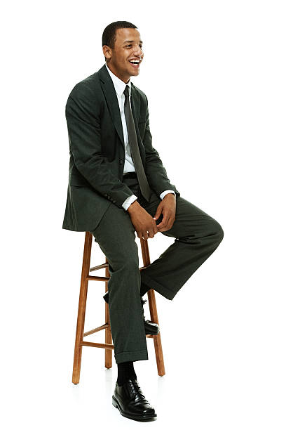 istock Cheerful businessman on stool and looking away 493655680