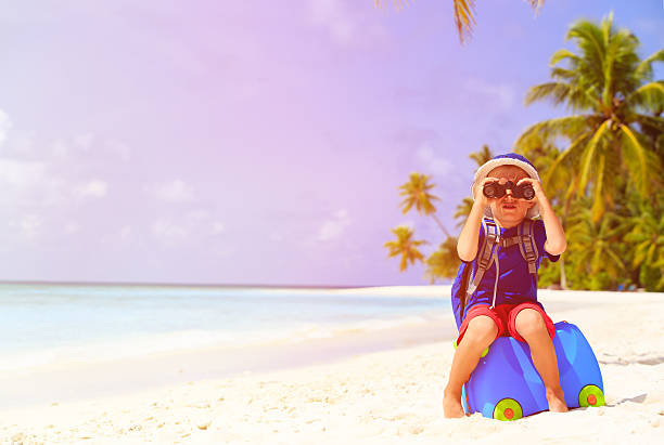 istock little boy travel on summer tropical beach 493655894