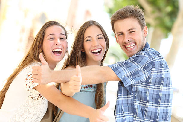 istock Three happy teenagers laughing with thumbs up 493656040