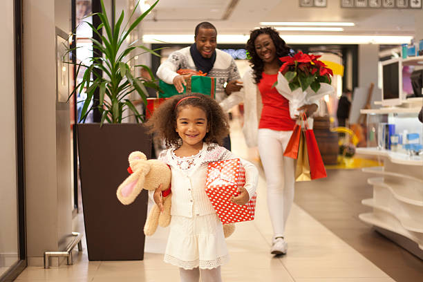 família em compras natal - spending money adult african ethnicity bag - fotografias e filmes do acervo