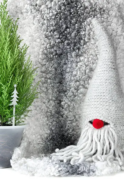 Christmas theme: traditional Scandinavian gnome, lambskin background. 