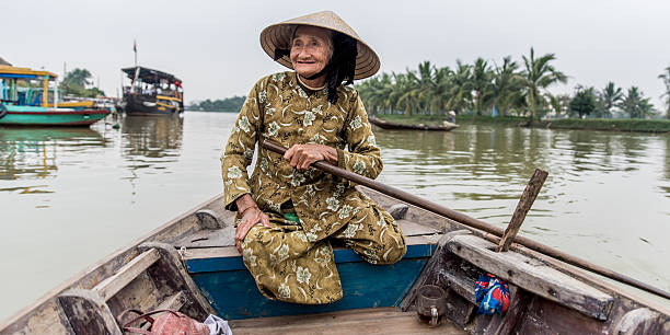 istock Old friendly woman with vietnamese straw hat 493657904