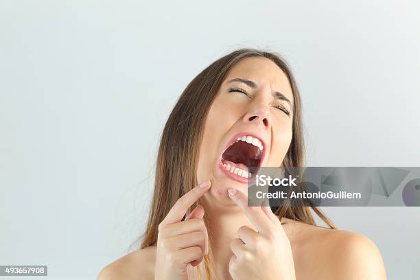 Girl Crying While Pressing A Pimple On Her Chin Stock Photo - Download Image Now - Pimple, 2015, Acne