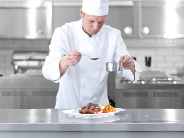 istock Male chef preparing steak plate 493657916