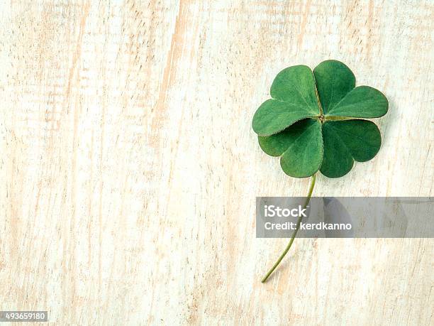 Closeup Clovers Leaves Setup On Wooden Background Stock Photo - Download Image Now