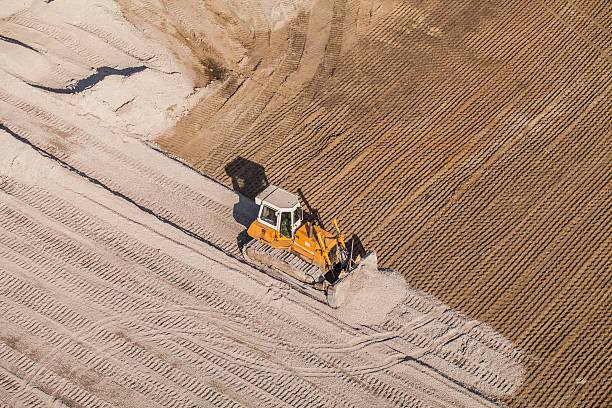 空から見た動作ショベルカー - earth mover working field dirt ストックフォトと画像