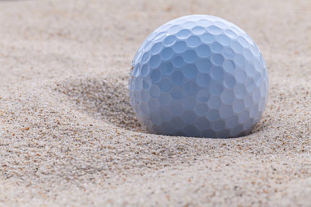 istock Close up golf ball in sand bunker . 493659630