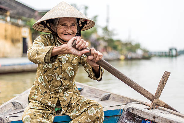 istock Old friendly woman with vietnamese straw hat 493660214