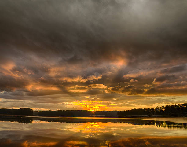 istock Cloudy sunrise over the lake 493660412