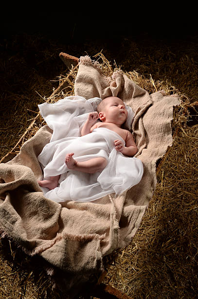 Baby Jesus on a Manger Baby Jesus wrapped in swaddling clothes on a manger immanuel stock pictures, royalty-free photos & images