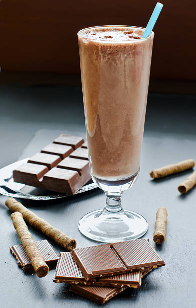istock Chocolate smoothie in glass on black background 493685058