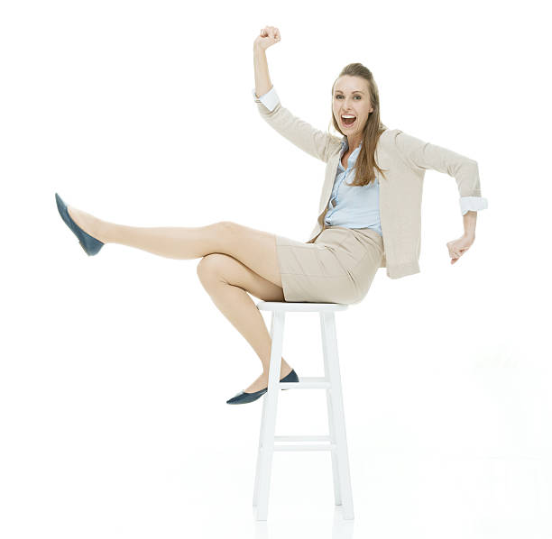 istock Cheerful businesswoman on stool and cheering 493685428