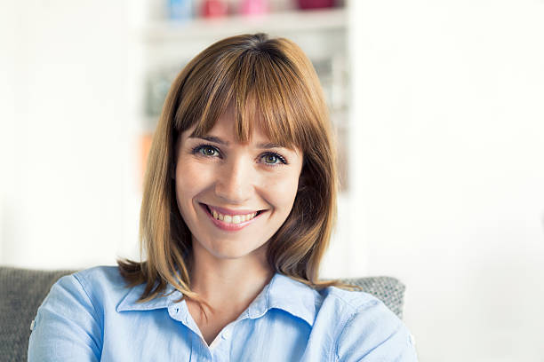 istock Thirty-year-old natural woman seated in modern home. Looking camera 493685764