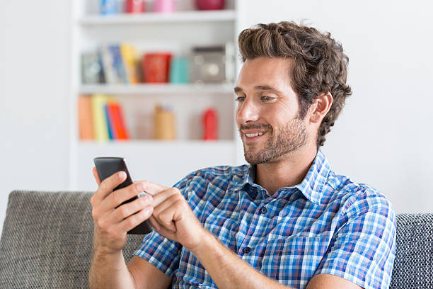 istock Mid adult man texting message on mobile phone 493686356
