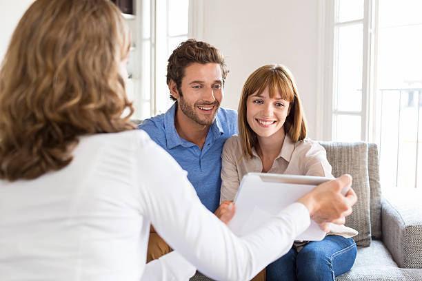 istock Architect presenting a new project on tablet to a couple 493687372