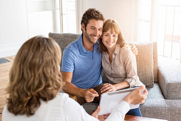 istock Architect presenting a new project on tablet to a couple 493687424